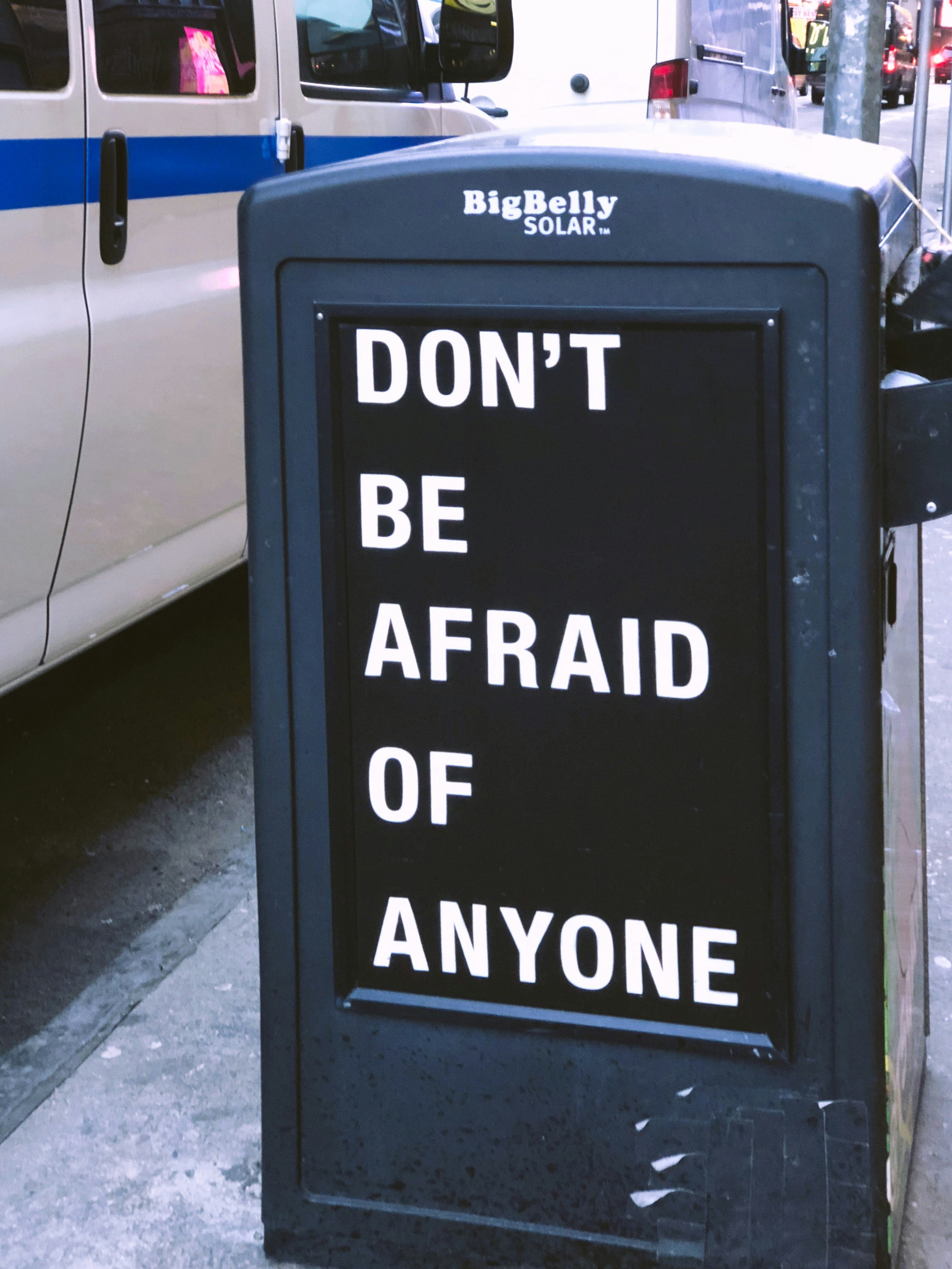 Don't be afraid of anyone sign near vehicle during daytime